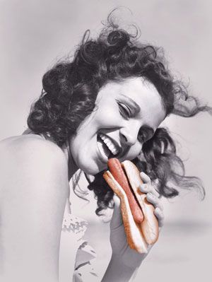 Sieviete ēšanas hotdog